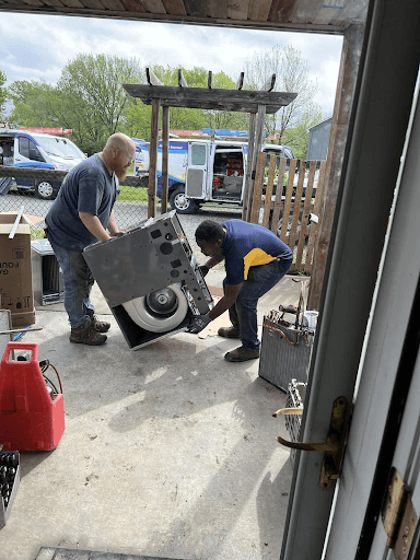 Team from Advantage Latta-Whitlow wheeling in a AC for HVAC installation in De Soto.