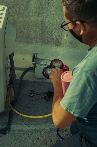 Advantage Latta-Whitlow HVAC technician hard at work on AC service